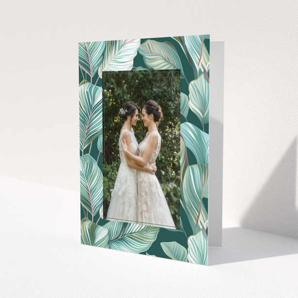 Wedding invitation design with tropical leaf pattern and one photo of a couple.