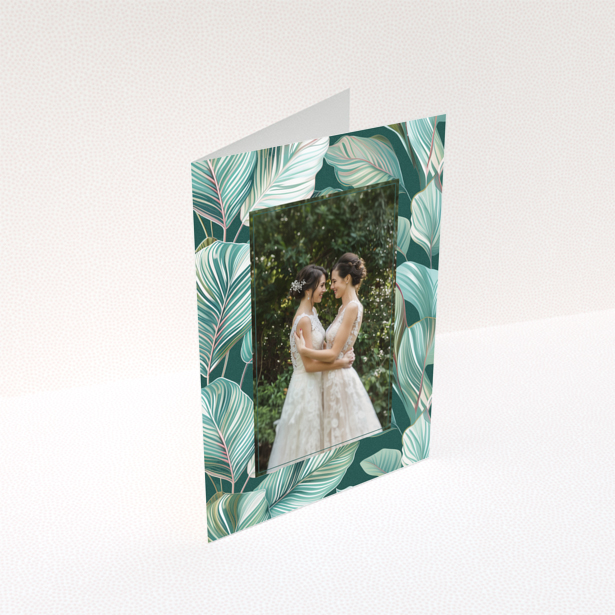 Wedding invitation design with tropical leaf pattern and one photo of a couple.