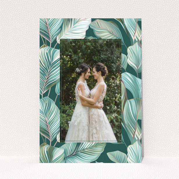 Wedding invitation design with tropical leaf pattern and one photo of a couple.