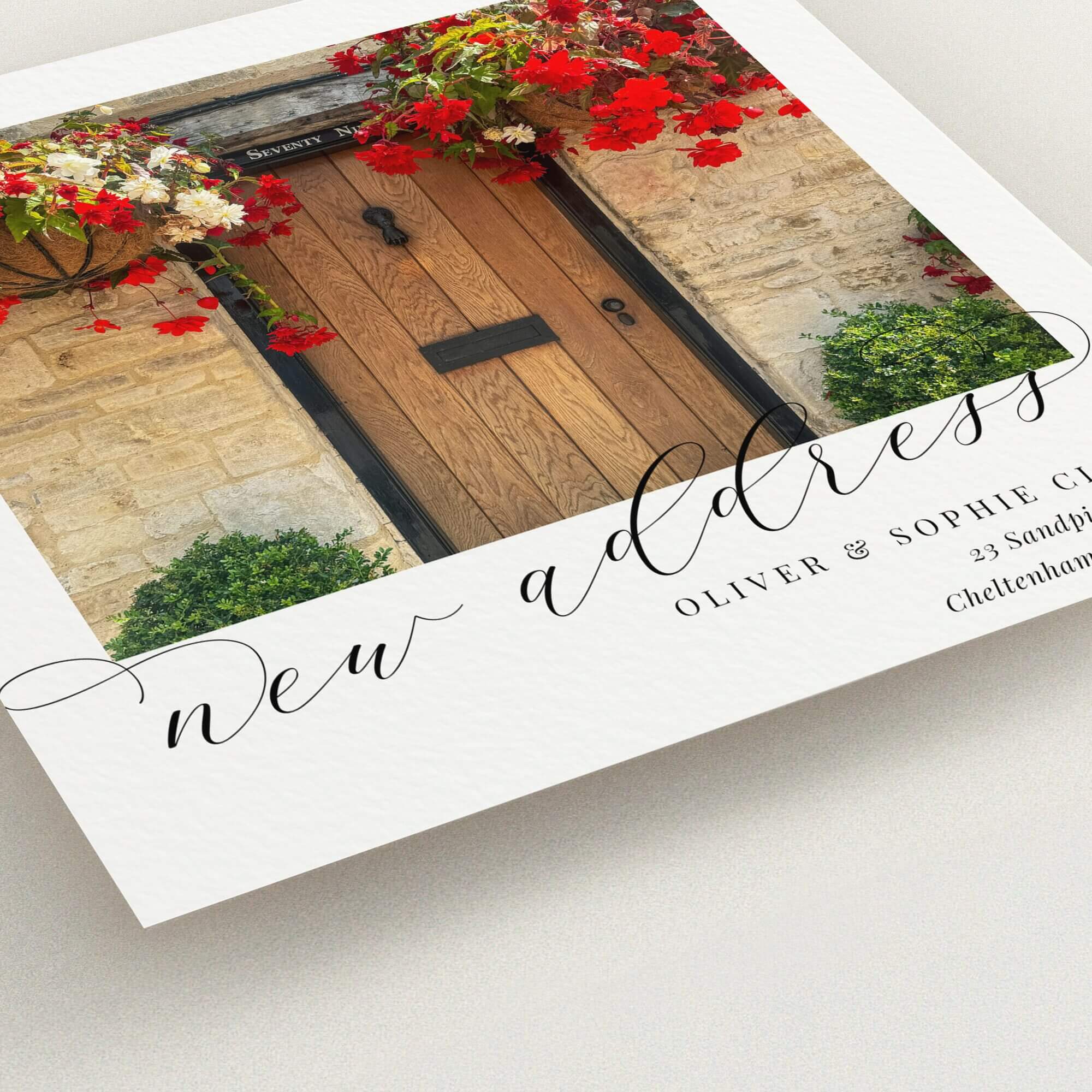 Change of address card with rustic door design and vibrant floral decorations, featuring one photo