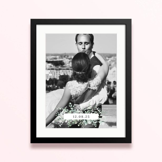 Framed and mounted photo print with a couple embracing and a date display.