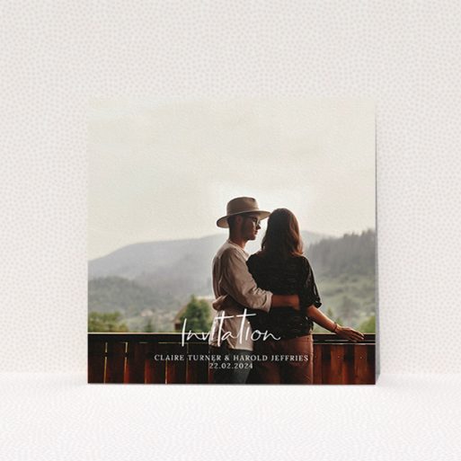 A wedding invite card named "Central Script". It is a square (148mm x 148mm) invite in a square orientation. It is a photographic wedding invite card with room for 1 photo. "Central Script" is available as a flat invite, with mainly white colouring.
