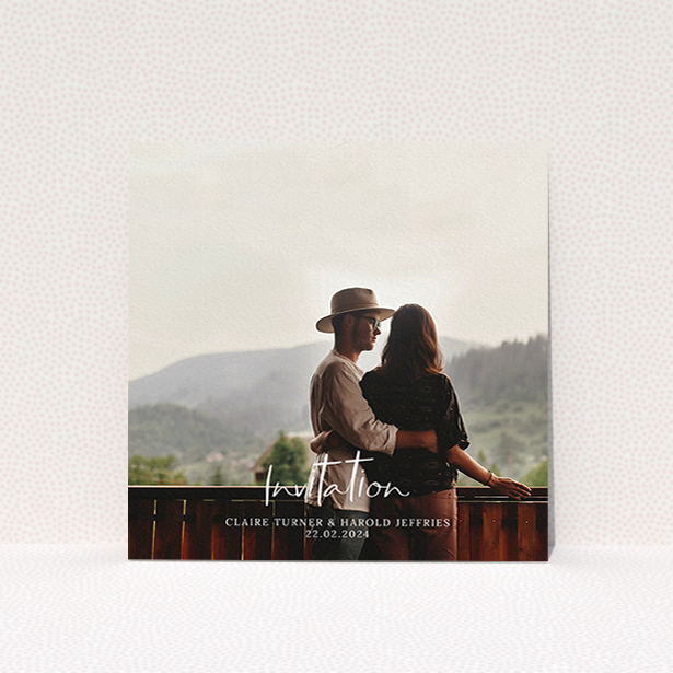 A wedding invite card named "Central Script". It is a square (148mm x 148mm) invite in a square orientation. It is a photographic wedding invite card with room for 1 photo. "Central Script" is available as a flat invite, with mainly white colouring.