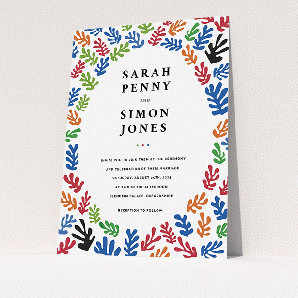 A wedding invite card called "Cut Out-esque". It is an A5 invite in a portrait orientation. "Cut Out-esque" is available as a flat invite, with tones of blue, red and green.