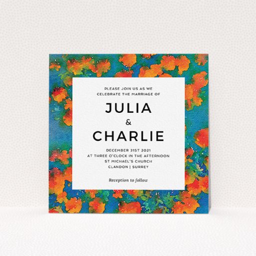 A wedding invite card called "Orange Bloom". It is a square (148mm x 148mm) invite in a square orientation. "Orange Bloom" is available as a flat invite, with tones of orange, blue and green.