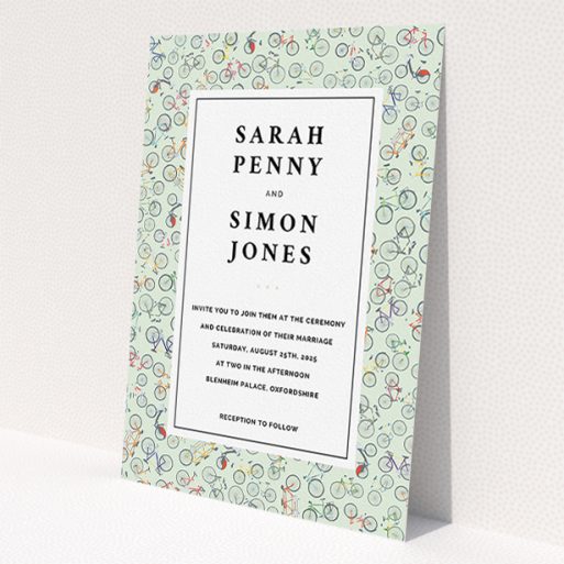 A wedding invite card named 'Peloton'. It is an A5 invite in a portrait orientation. 'Peloton' is available as a flat invite, with tones of green, red and grey.