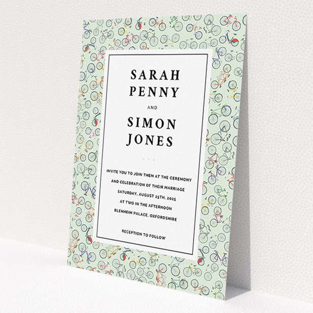 A wedding invite card named "Peloton". It is an A5 invite in a portrait orientation. "Peloton" is available as a flat invite, with tones of green, red and grey.