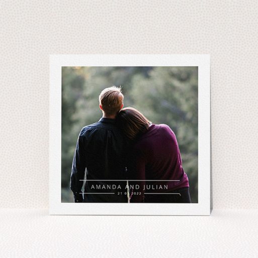 A wedding invite card named "Tramlines". It is a square (148mm x 148mm) invite in a square orientation. It is a photographic wedding invite card with room for 1 photo. "Tramlines" is available as a flat invite, with mainly white colouring.
