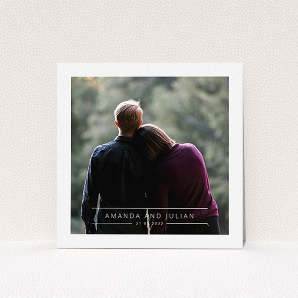 A wedding invite card named "Tramlines". It is a square (148mm x 148mm) invite in a square orientation. It is a photographic wedding invite card with room for 1 photo. "Tramlines" is available as a flat invite, with mainly white colouring.