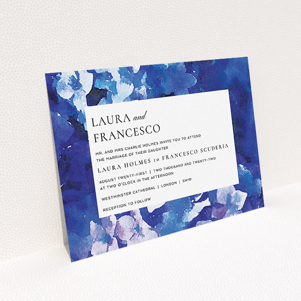 A wedding invite card called "Violets". It is an A5 invite in a landscape orientation. "Violets" is available as a flat invite, with tones of deep violet, light blue and light purple.