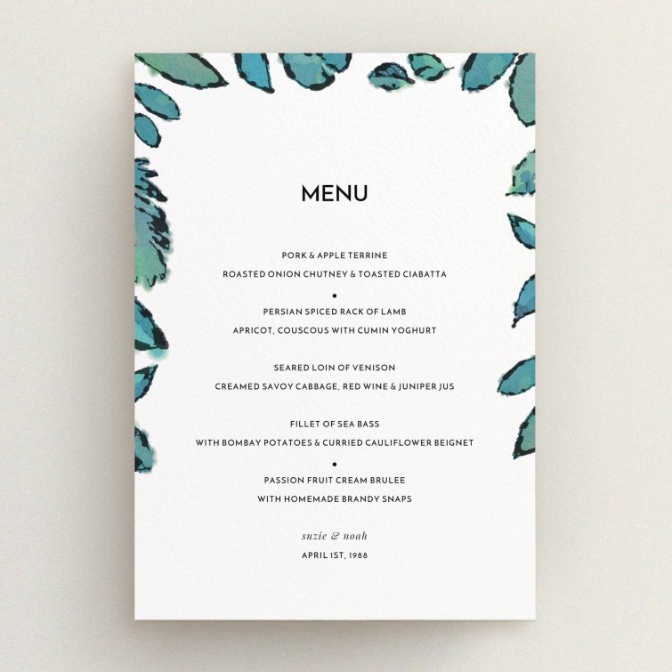 A wedding menu card design called "Woodland Flourish". It is an A5 menu in a portrait orientation. "Woodland Flourish" is available as a flat menu, with tones of green and white.