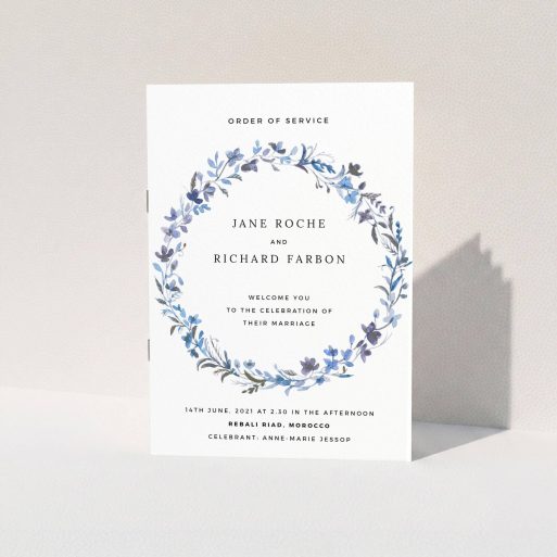 A wedding order of service design titled "Blue Wildflower". It is an A5 booklet in a portrait orientation. "Blue Wildflower" is available as a folded booklet booklet, with tones of light blue, purple and grey.