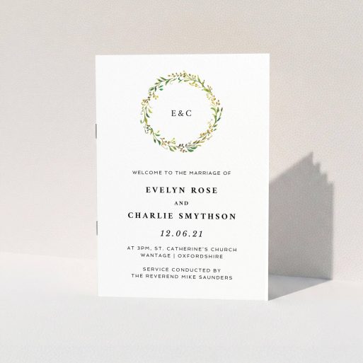 A wedding order of service called "Classic Monogrammed Wreath". It is an A5 booklet in a portrait orientation. "Classic Monogrammed Wreath" is available as a folded booklet booklet, with tones of white and green.
