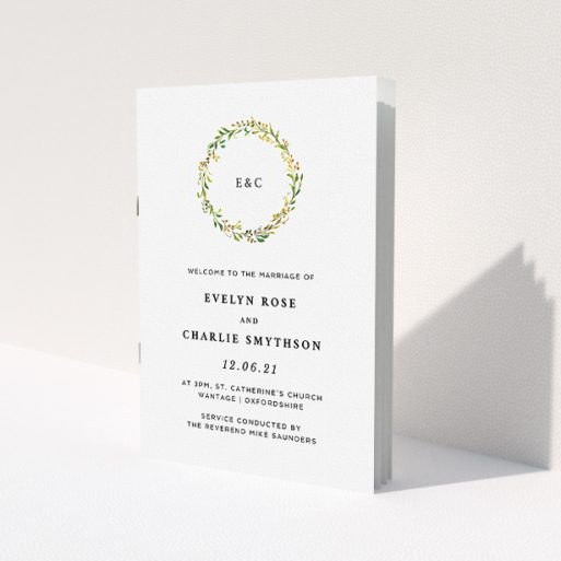 A wedding order of service called 'Classic Monogrammed Wreath'. It is an A5 booklet in a portrait orientation. 'Classic Monogrammed Wreath' is available as a folded booklet booklet, with tones of white and green.