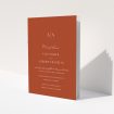 A wedding order of service named "Dark Ochre Monogrammed". It is an A5 booklet in a portrait orientation. "Dark Ochre Monogrammed" is available as a folded booklet booklet, with mainly dark orange colouring.