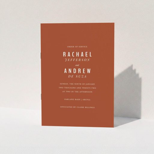 A wedding order of service named "Ochre with Typography". It is an A5 booklet in a portrait orientation. "Ochre with Typography" is available as a folded booklet booklet, with mainly dark orange colouring.