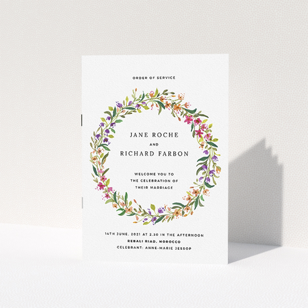A wedding order of service named "Spring Wildflower". It is an A5 booklet in a portrait orientation. "Spring Wildflower" is available as a folded booklet booklet, with tones of light green and orange.