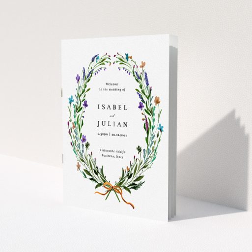 A wedding order of service named 'Spring Wildflower Wreath'. It is an A5 booklet in a portrait orientation. 'Spring Wildflower Wreath' is available as a folded booklet booklet, with tones of green and purple.
