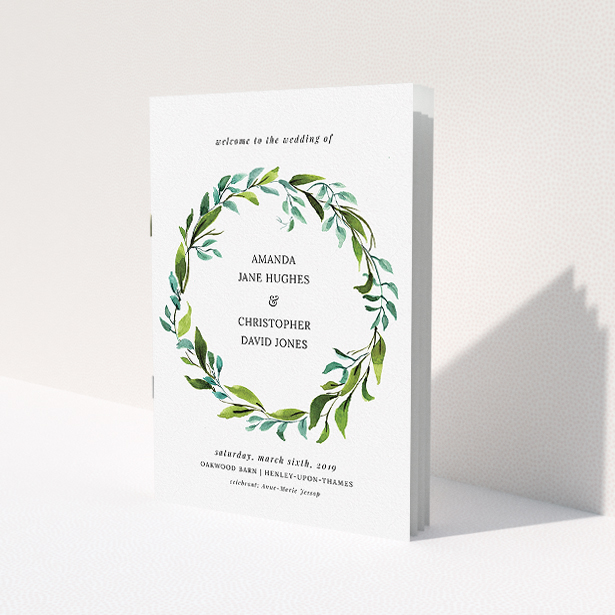 A wedding order of service design named 'Watercolour Wreath Cover'. It is an A5 booklet in a portrait orientation. 'Watercolour Wreath Cover' is available as a folded booklet booklet, with tones of green and light blue.