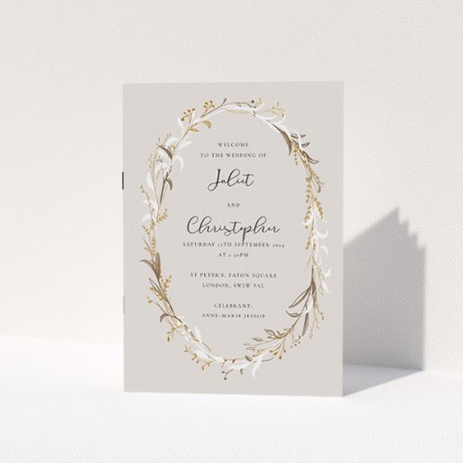 A wedding program named "Winter Wedding Order of Service". It is an A5 booklet in a portrait orientation. "Winter Wedding Order of Service" is available as a folded booklet booklet, with tones of dark cream and gold.