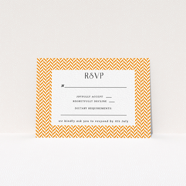 A wedding response card called "Orange Houndstooth". It is an A7 card in a landscape orientation. "Orange Houndstooth" is available as a flat card, with tones of orange and white.