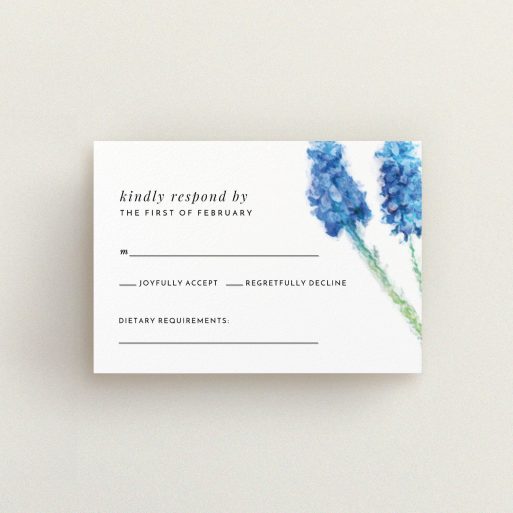 A wedding rsvp card design named "A new bloom". It is an A7 card in a landscape orientation. "A new bloom" is available as a flat card, with tones of blue and white.