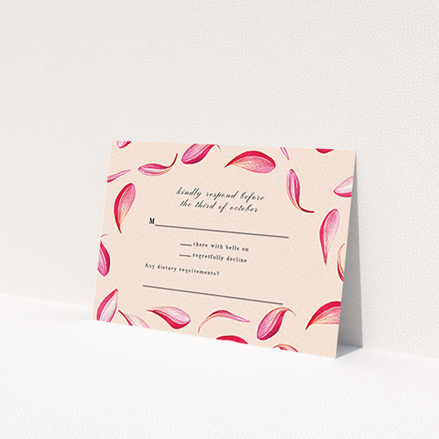 A wedding rsvp card named "Petal avalanche". It is an A7 card in a landscape orientation. "Petal avalanche" is available as a flat card, with tones of pink, red and white.