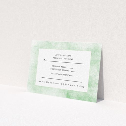 A wedding rsvp card named 'Rustic Green'. It is an A7 card in a landscape orientation. 'Rustic Green' is available as a flat card, with tones of green and white.