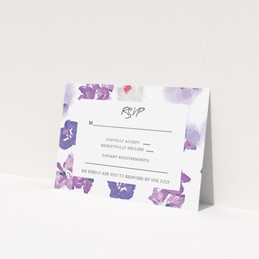 A wedding rsvp card named 'Violet Explosion'. It is an A7 card in a landscape orientation. 'Violet Explosion' is available as a flat card, with mainly purple/dark pink colouring.