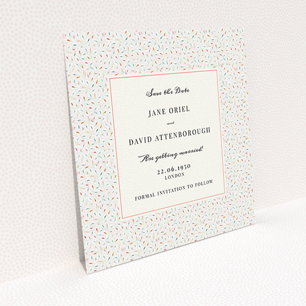 A wedding save the date card named "A hint of confetti". It is a square (148mm x 148mm) card in a square orientation. "A hint of confetti" is available as a flat card, with tones of light cream and green.