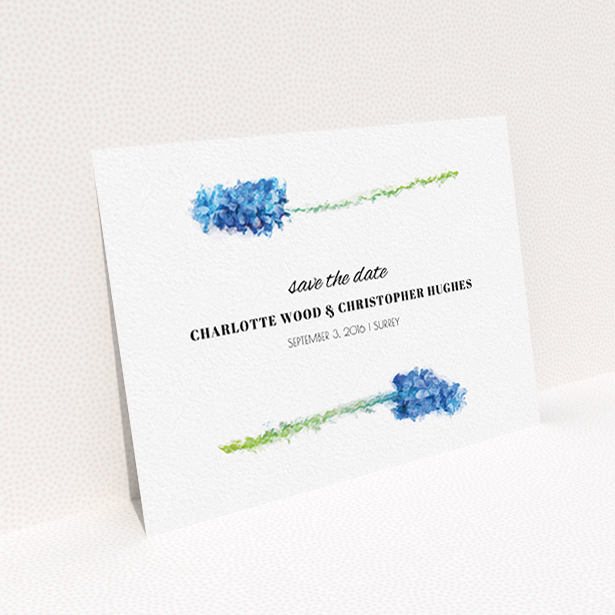 A wedding save the date card called "A new bloom". It is an A6 card in a landscape orientation. "A new bloom" is available as a flat card, with tones of blue and white.