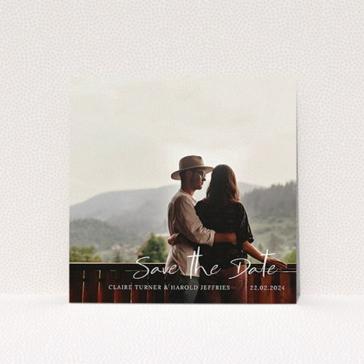 A wedding save the date card design named "Central Script". It is a square (148mm x 148mm) card in a square orientation. It is a photographic wedding save the date card with room for 1 photo. "Central Script" is available as a flat card, with mainly white colouring.