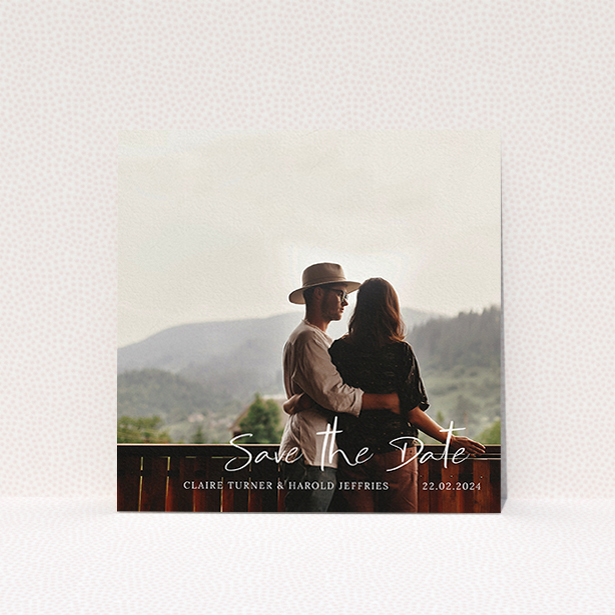 A wedding save the date card design named "Central Script". It is a square (148mm x 148mm) card in a square orientation. It is a photographic wedding save the date card with room for 1 photo. "Central Script" is available as a flat card, with mainly white colouring.