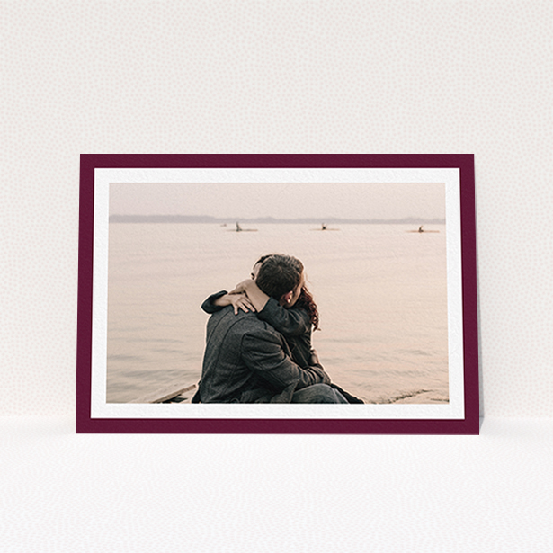 A wedding save the date card design named "Classic Burgundy Photo Frame". It is an A6 card in a landscape orientation. It is a photographic wedding save the date card with room for 1 photo. "Classic Burgundy Photo Frame" is available as a flat card, with tones of burgundy and white.