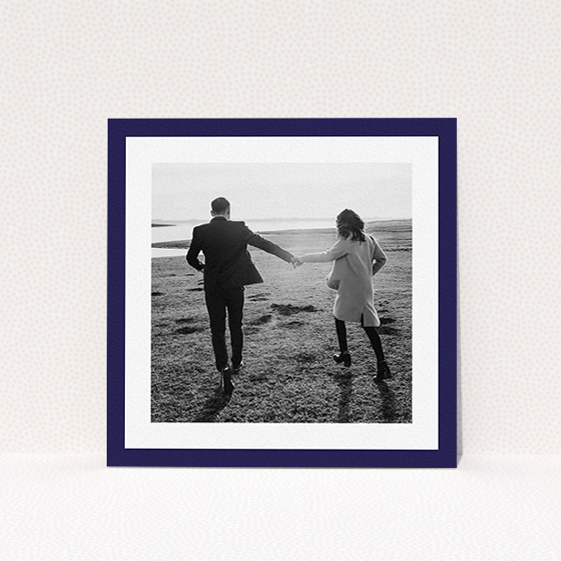 A wedding save the date card design named "Classic Navy Photo Frame". It is a square (148mm x 148mm) card in a square orientation. It is a photographic wedding save the date card with room for 1 photo. "Classic Navy Photo Frame" is available as a flat card, with tones of blue and white.
