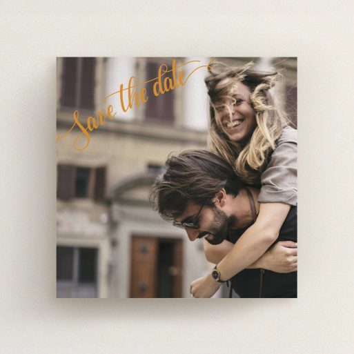 A wedding save the date card named "Corner Typography Photo". It is a square (148mm x 148mm) card in a square orientation. It is a photographic wedding save the date card with room for 1 photo. "Corner Typography Photo" is available as a flat card, with mainly light orange colouring.
