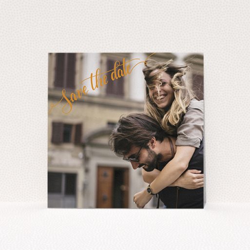 A wedding save the date card named "Corner Typography Photo". It is a square (148mm x 148mm) card in a square orientation. It is a photographic wedding save the date card with room for 1 photo. "Corner Typography Photo" is available as a flat card, with mainly light orange colouring.