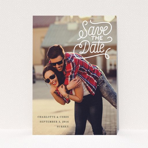 A wedding save the date card design named "Curly Typography Photo". It is an A5 card in a portrait orientation. It is a photographic wedding save the date card with room for 1 photo. "Curly Typography Photo" is available as a flat card, with mainly white colouring.