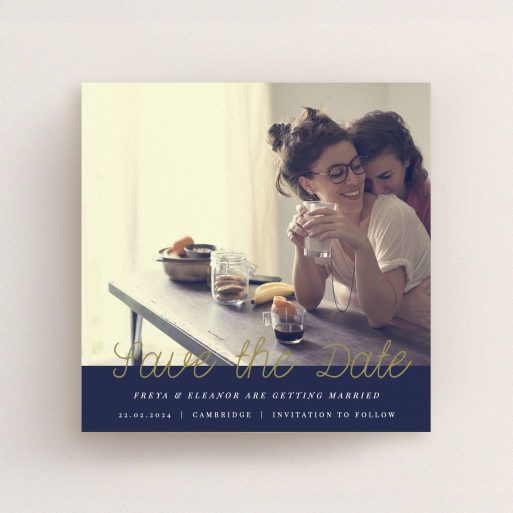 A wedding save the date card template titled "Gold on Navy Blue". It is a square (148mm x 148mm) card in a square orientation. It is a photographic wedding save the date card with room for 1 photo. "Gold on Navy Blue" is available as a flat card, with tones of navy blue and white.
