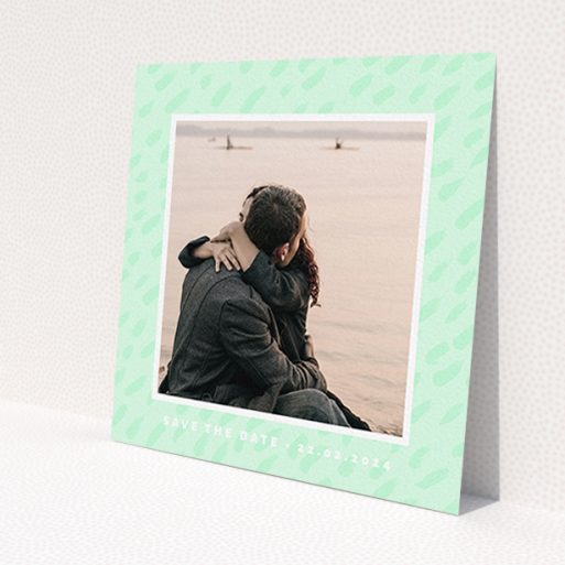 A wedding save the date card design named 'Green Photo Frame'. It is a square (148mm x 148mm) card in a square orientation. It is a photographic wedding save the date card with room for 1 photo. 'Green Photo Frame' is available as a flat card, with tones of green and white.