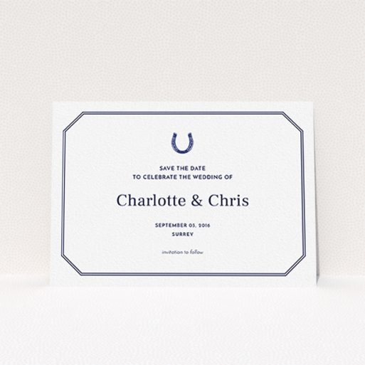 A wedding save the date card named "Lucky horse shoe". It is an A6 card in a landscape orientation. "Lucky horse shoe" is available as a flat card, with tones of navy blue and white.