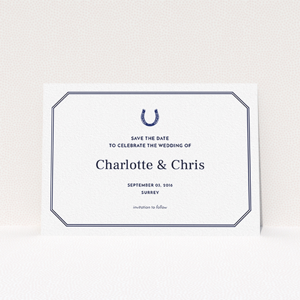 A wedding save the date card named "Lucky horse shoe". It is an A6 card in a landscape orientation. "Lucky horse shoe" is available as a flat card, with tones of navy blue and white.