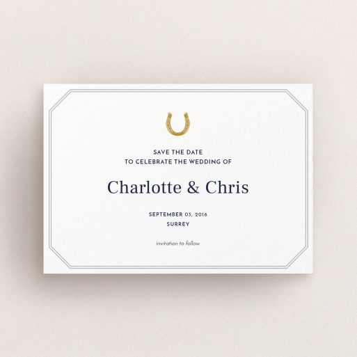 A wedding save the date card named "Lucky horse shoe". It is an A6 card in a landscape orientation. "Lucky horse shoe" is available as a flat card, with tones of white and grey.