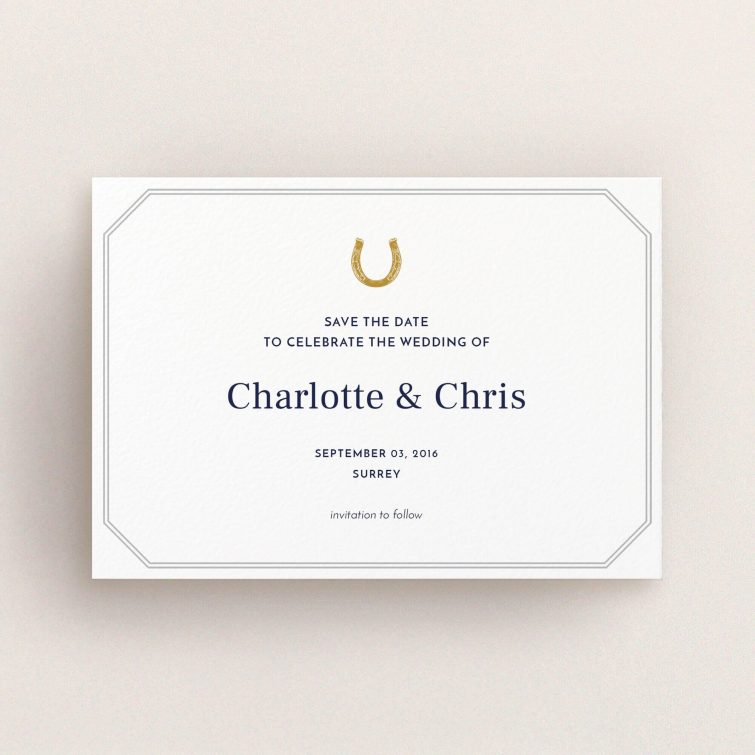 A wedding save the date card named "Lucky horse shoe". It is an A6 card in a landscape orientation. "Lucky horse shoe" is available as a flat card, with tones of white and grey.