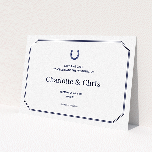 A wedding save the date card named "Lucky horse shoe". It is an A6 card in a landscape orientation. "Lucky horse shoe" is available as a flat card, with tones of navy blue and white.