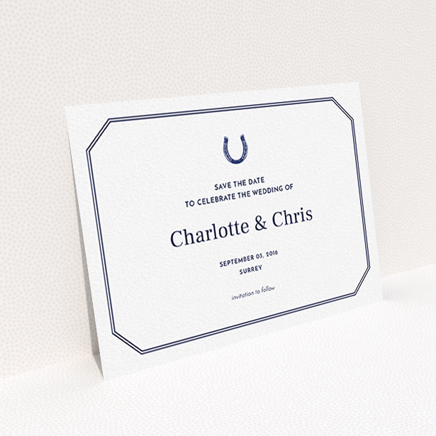 A wedding save the date card named "Lucky horse shoe". It is an A6 card in a landscape orientation. "Lucky horse shoe" is available as a flat card, with tones of navy blue and white.