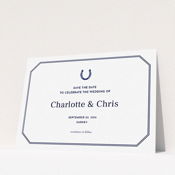 A wedding save the date card named "Lucky horse shoe". It is an A6 card in a landscape orientation. "Lucky horse shoe" is available as a flat card, with tones of navy blue and white.