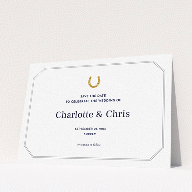 A wedding save the date card named "Lucky horse shoe". It is an A6 card in a landscape orientation. "Lucky horse shoe" is available as a flat card, with tones of white and grey.