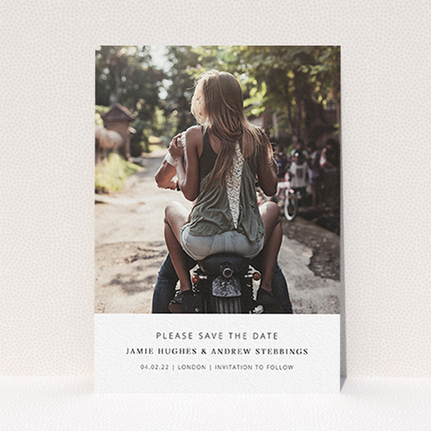 A wedding save the date card design named "Maddox Street". It is an A6 card in a portrait orientation. It is a photographic wedding save the date card with room for 1 photo. "Maddox Street" is available as a flat card, with mainly white colouring.