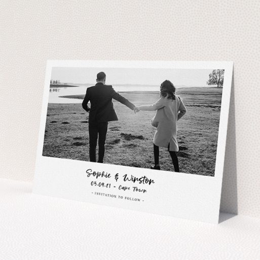 A wedding save the date card template titled 'Monochrome Photo'. It is an A5 card in a landscape orientation. It is a photographic wedding save the date card with room for 1 photo. 'Monochrome Photo' is available as a flat card, with mainly white colouring.